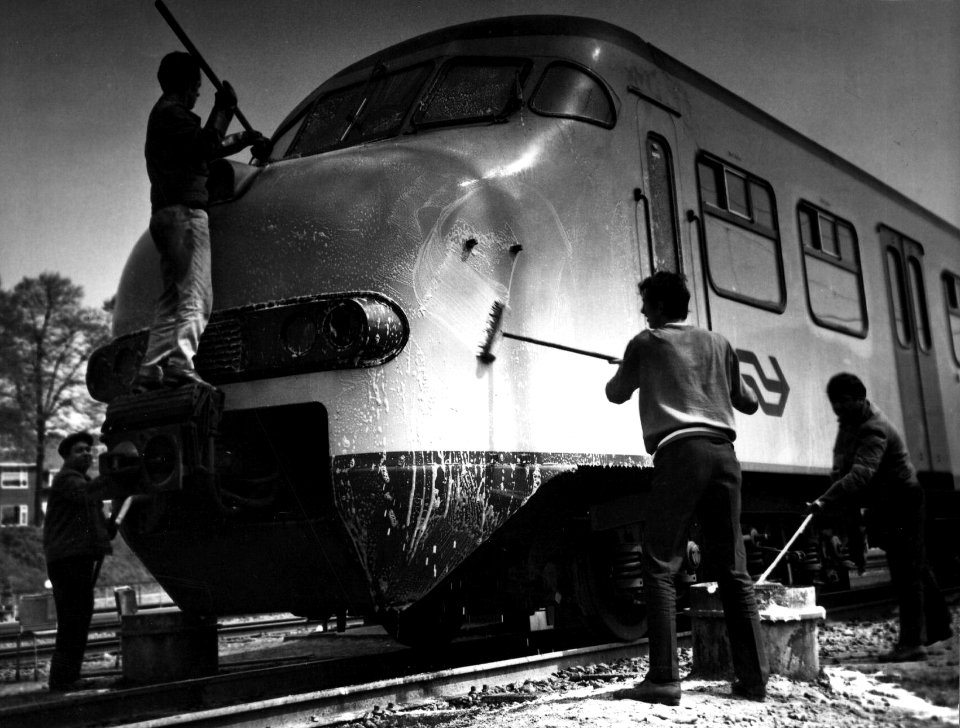 HUA-153509-Afbeelding van het schoonboenen van de neus van een electrisch treinstel plan V mat 1964 van de NS op het emplacment Arnhem Berg te Arnhem
