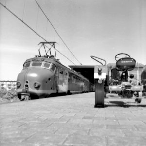 HUA-167047-Afbeelding van het vervoer van landbouwtractoren per trein voor de firma Deutz op het N.S.-station Amsterdam Amstel te Amsterdam, met links een electrisch treinstel plan P (mat. 1954) van de N.S