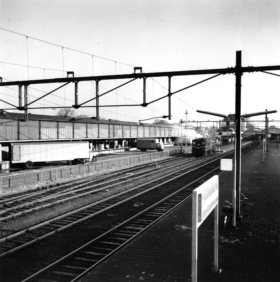 HUA-166758-Gezicht op het N.S.-station Leeuwarden te Leeuwarden, met op de achtergrond de loods van Van Gend & Loos
