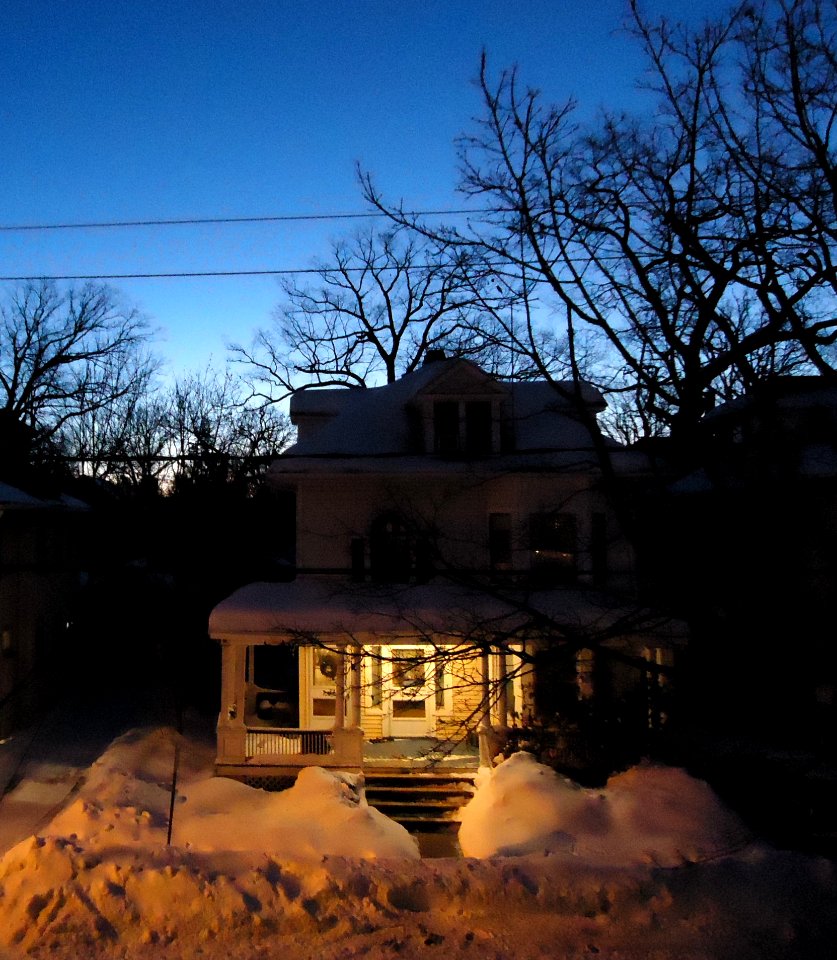 House at dawn in snow with blue sky in February