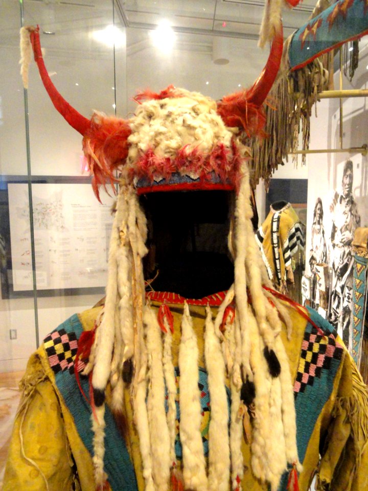 Horned bonnet of weasel skins, worn by Grass Dance leader, Blackfoot, Alberta, c. 1900, with ceremonial shirt, Blackfoot, c. 1880 - Royal Ontario Museum - DSC00325