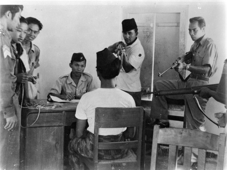 Indonesische man op de rug gezien wordt ondervraagd en onder schot gehouden in , Bestanddeelnr 8803