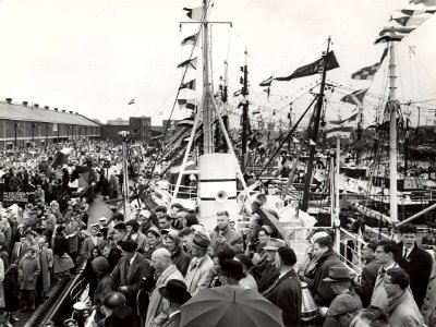 In de Vissershaven werd vlaggetjesdag gevierd met een optocht langs minister Mansholt (achter de microfoon). Aangekocht in 1977 van fotograaf C. de Boer. Identificatienummer 54-005542