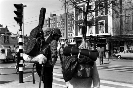 In Amsterdam begint de toeristenstroom voor pasen al op gang te komen, twee jonge toeristen met rugzakken en muziek-instrumenten, Bestanddeelnr 931-4294