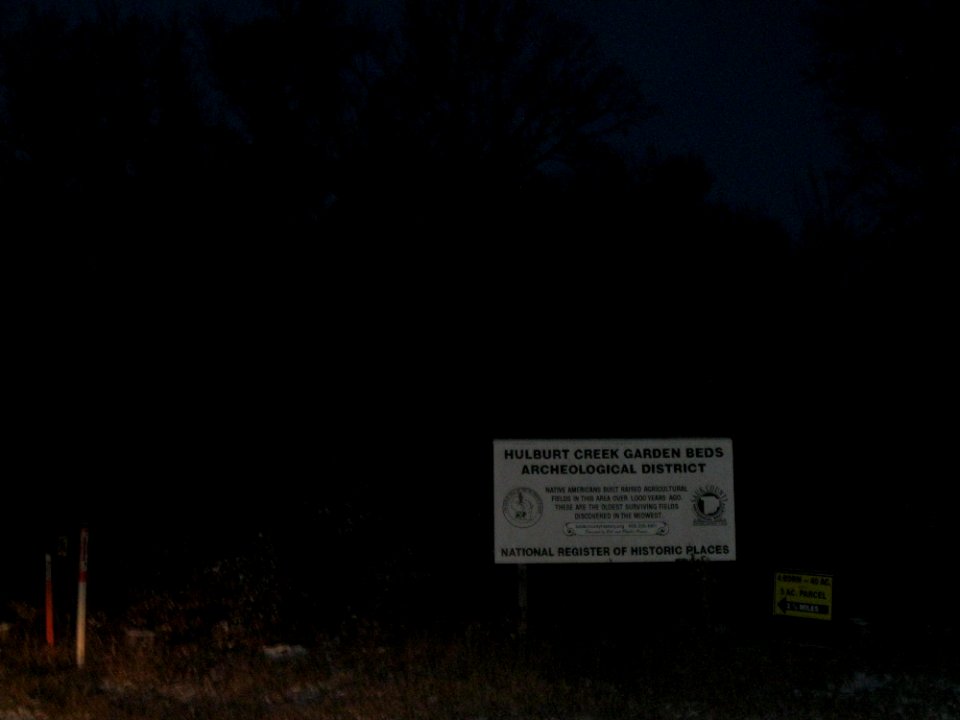 Hulburt Creek Garden Beds sign at dusk