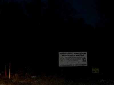 Hulburt Creek Garden Beds sign at dusk