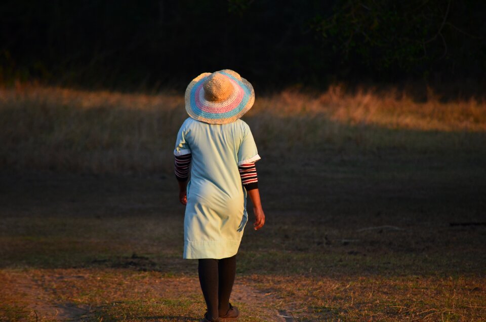 Female back hat woman go for a walk