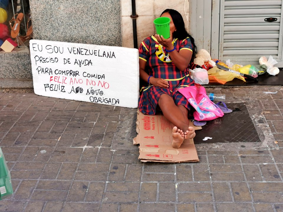 Immigrant Venezuelan homeless asking for help in the street