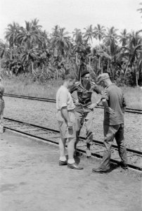 Jonkheer G.A.M.J. Ruijs de Beerenbrouck, in bermuda, in gesprek met twee officie, Bestanddeelnr 194-2-6