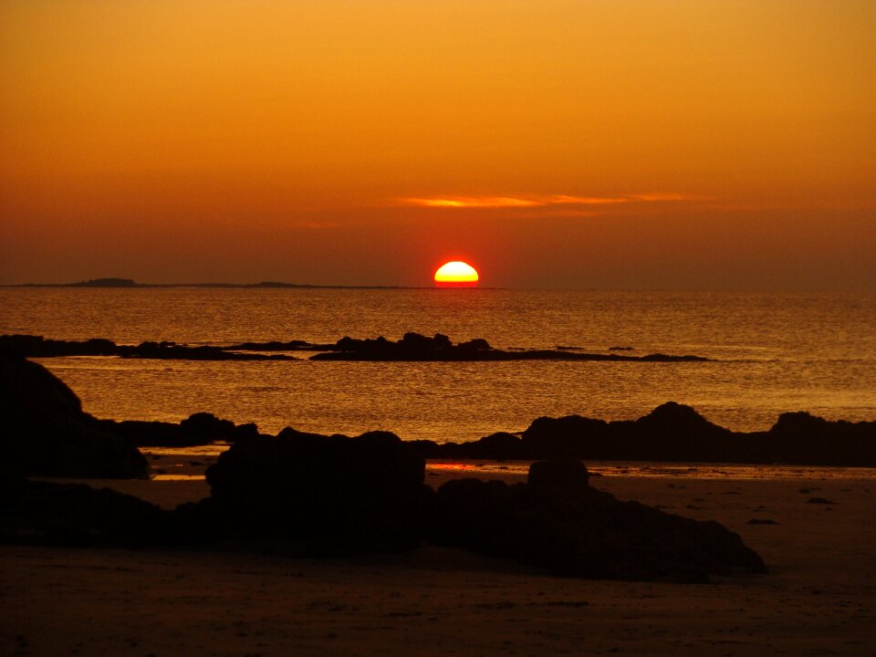 Sun dipping sea rocks