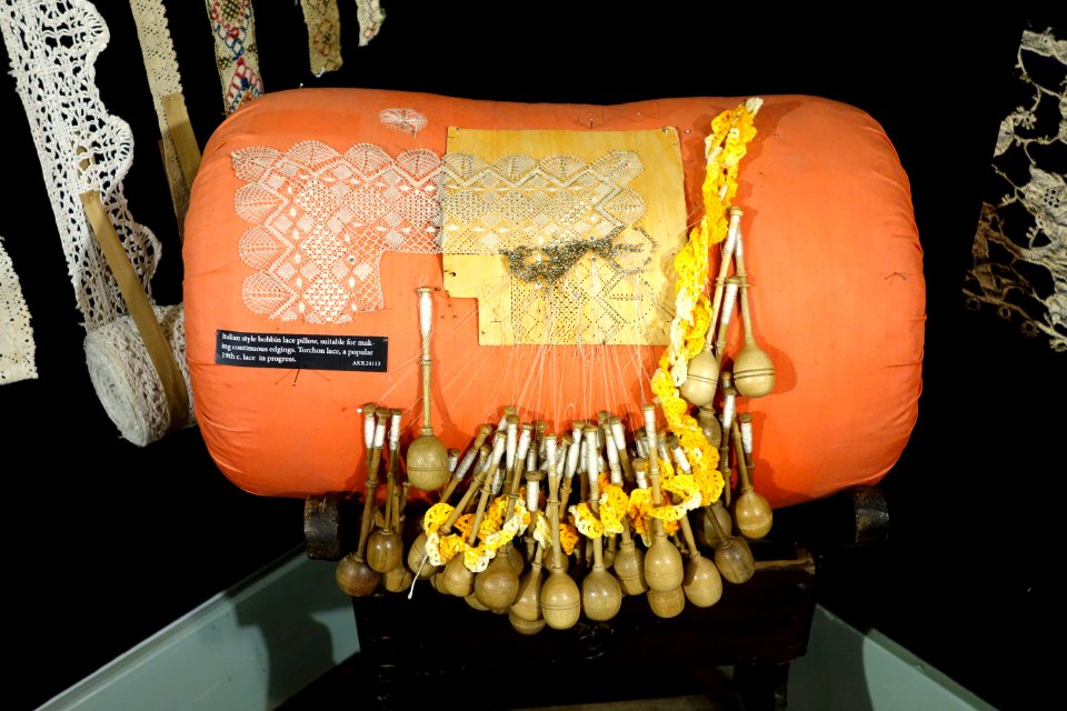 Italian style bobbin lace pillow, with torchon lace in progress - Lacis Museum of Lace and Textiles - Berkeley, CA - DSC04597