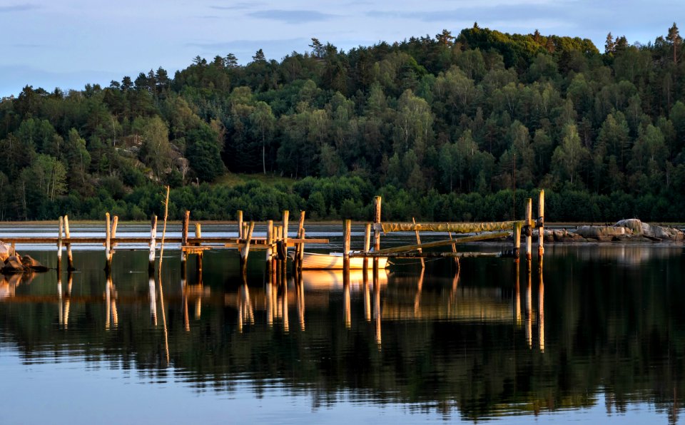 Jetty and boat at golden hour in Norrkila photo