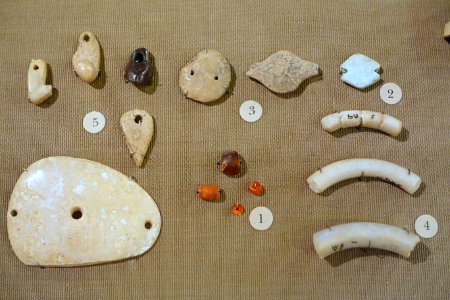Jarmo personal adornments, 1 carnelian beads, 2 turquoise bead, 3 clay beads, 4 stone bracelets, 5 pendants of clay, stone, and shell - Oriental Institute Museum, University of Chicago - DSC06938