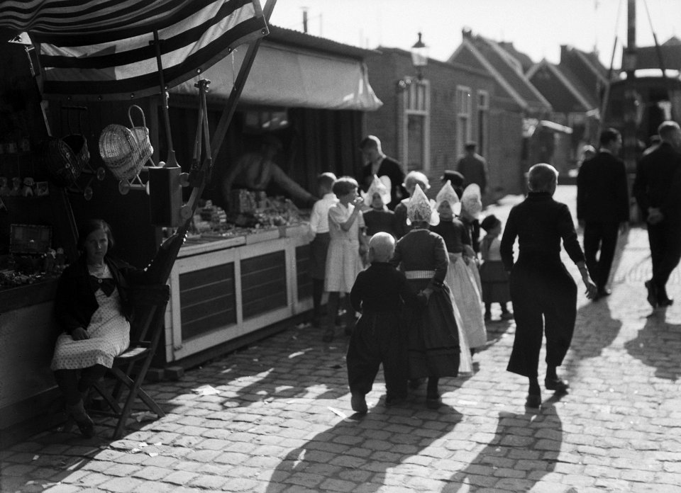Kinderen in klederdracht in Volendam bij een marktkraam, Bestanddeelnr 190-1121