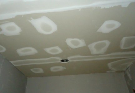 Kitchen renovation spackling to cover holes and tape between sheetrock boards photo