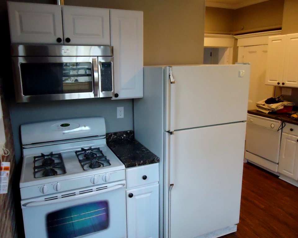 Kitchen renovation project cabinets finished microwave installed new floor painted walls and ceiling