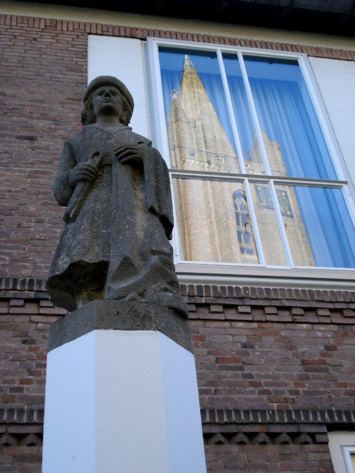 Kapelle town hall - statue and reflection of churchtower
