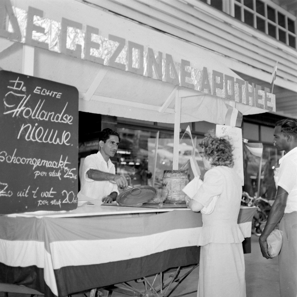 Kar met opschrift 'De Gezonde Apotheek' met Hollandse Nieuwe in Paramaribo, Bestanddeelnr 252-4887