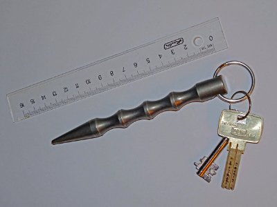 Kubotan key ring with ruler to indicate scale photo