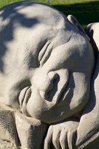 Face satisfaction sand sculpture photo