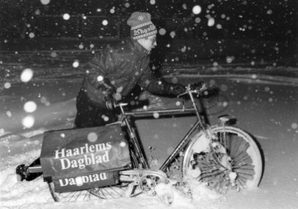 Krantenbezorger in de sneeuw aan het werk. NL-HlmNHA 5400464934