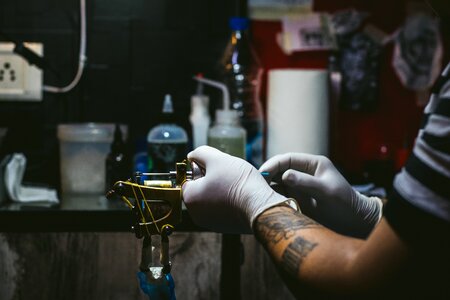 Tattooist tattooing machine photo