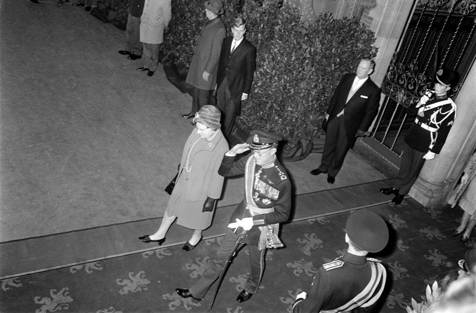 Koningin Juliana en prins Bernhard verlaten het Centraal station van Amsterdam, Bestanddeelnr 923-0066