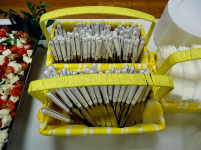 Knives and forks in yellow baskets with handles