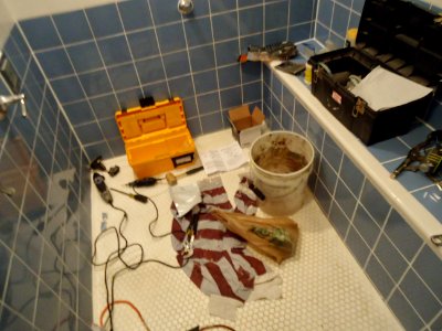 Kohler shower valve replacement tools on floor of shower