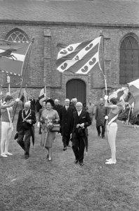 Koningin Juliana en de heer A. Holkema lopen onder de Friese vlag door, Bestanddeelnr 919-2934