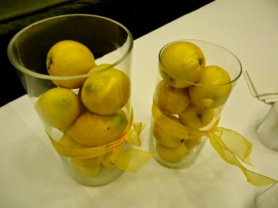 Lemons piled in glass vases at a party