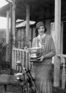 Lady holding the Llandrindod Wells Open Challenge Bowl outside Llandrindod Wells Golf Club pavilion (1294084)