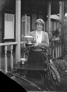 Lady holding a cup outside Llandrindod Wells Golf Club pavilion (1294149)