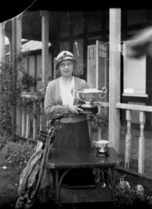 Lady holding a cup outside Llandrindod Wells Golf Club pavilion (1294271)
