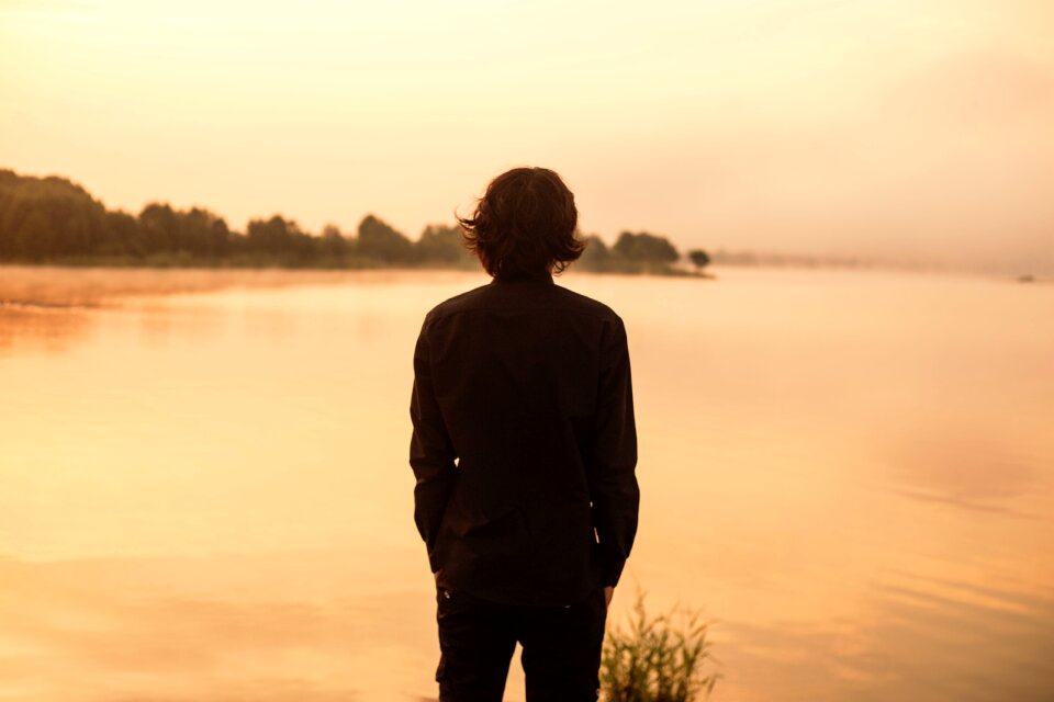 Black shirt mountain lake