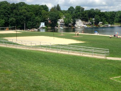 Lake Hopatcong view with grass and trees and volleyball area