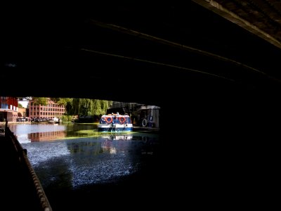 London - Camden - Regent's canal, boat from under a bridge