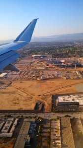 Los Angeles Stadium under construction with Inglewood Forum in background 