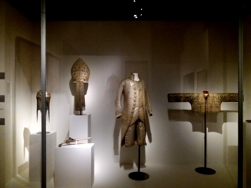 Lyon 2e - Musée des Tissus et des Arts décoratifs, vitrine avec mitre, casque, pistolet, habit et veste