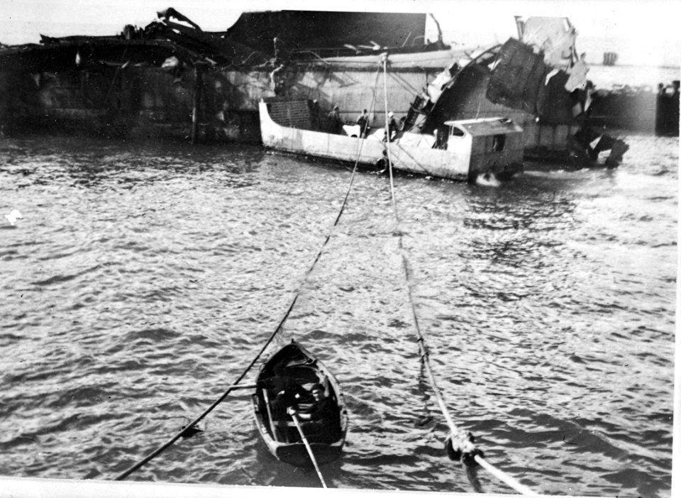 Lijnen zijn gespannen van een wrak van een schip naar een sleepboot Op de voor, Bestanddeelnr 935-3199