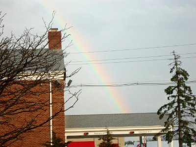 Light rainbow behind bank alongside Route 22 in New Jersey