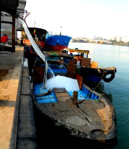 Loading boat with chipped ice at a port 01