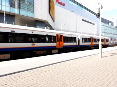 London - Shepherd's Bush railway station with train, and Westfield Shopping Centre photo