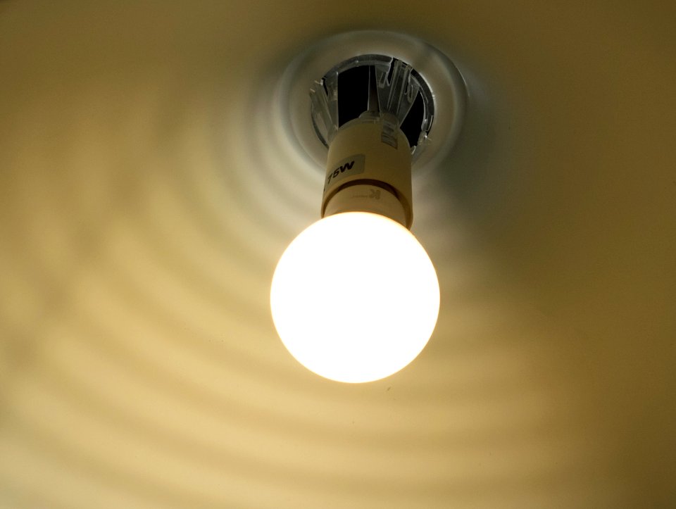 Lit LED bulb inside a white shade