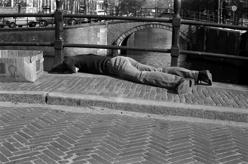 Man, liggend op brug draait lampjes in voor feestverlichting in Amsterdam, Bestanddeelnr 927-1517