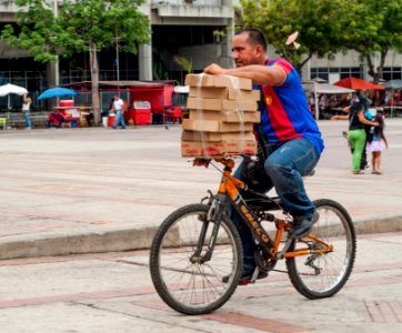 Man carrying boxes on a bicycle