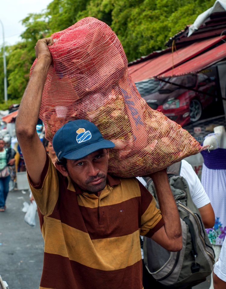 Man carrying peppers photo