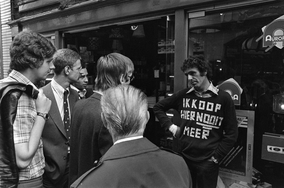 Man protesteert bij winkel in Amsterdam in verband met miskoop met tekst op T-sh, Bestanddeelnr 929-2786