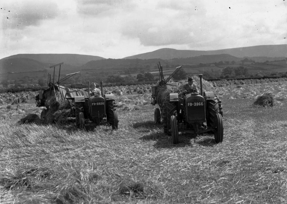 Man and woman harvesting with tractors (1294464)