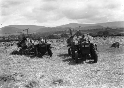 Man and woman harvesting with tractors (1294814)
